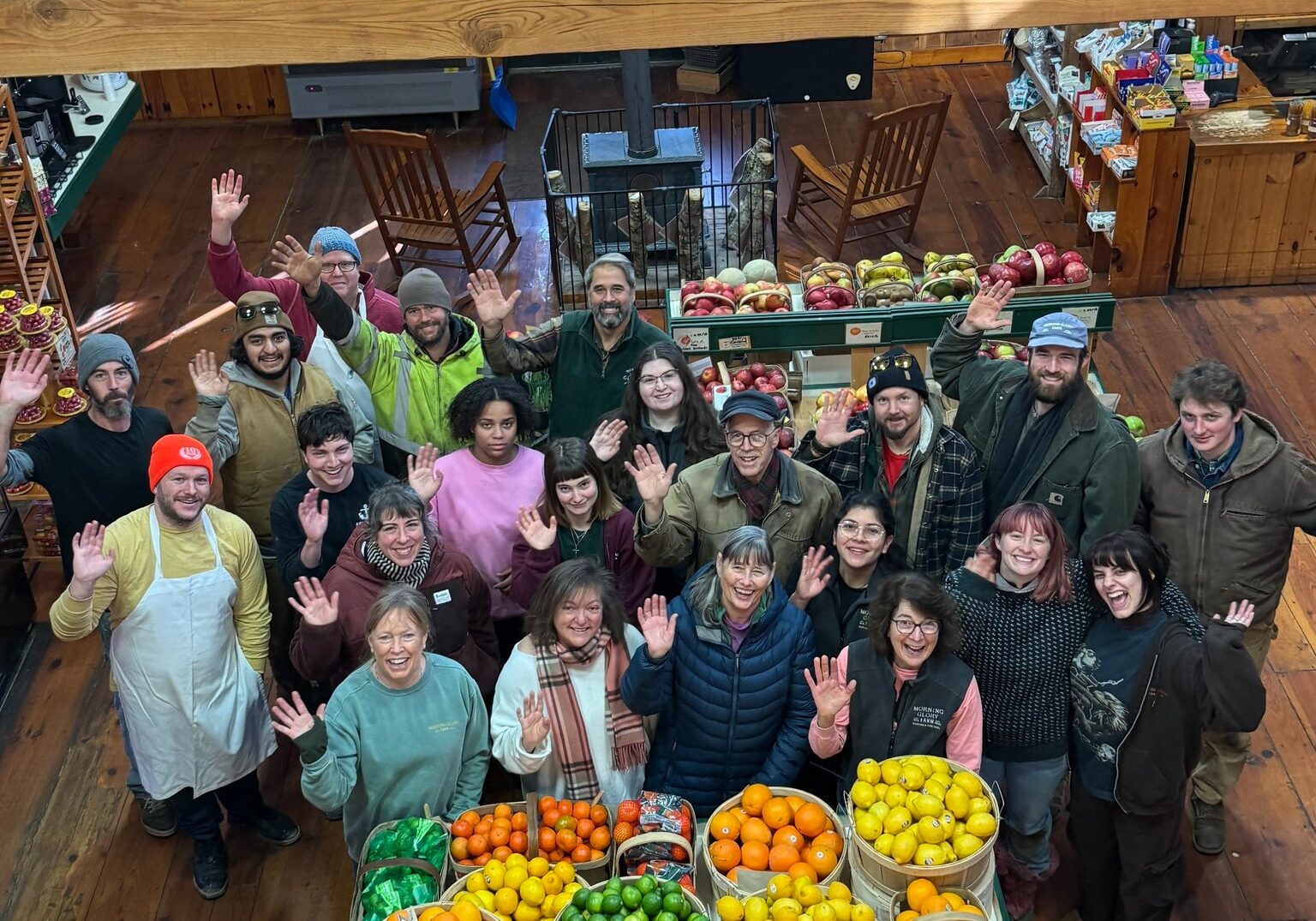 Farmstand bakery team at Morning Glory Farm surrounded by fresh produce inside the farmstand