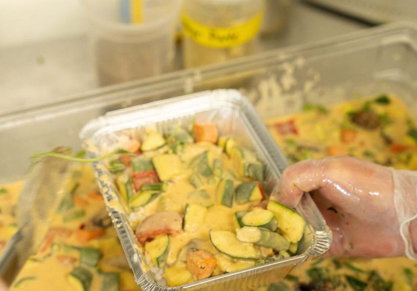 Preparing and packaging Prepared Farm Fresh Meals made with fresh vegetables from Morning Glory Farm.